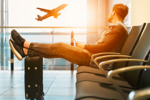 Homme dans un aéroport avec sa valise