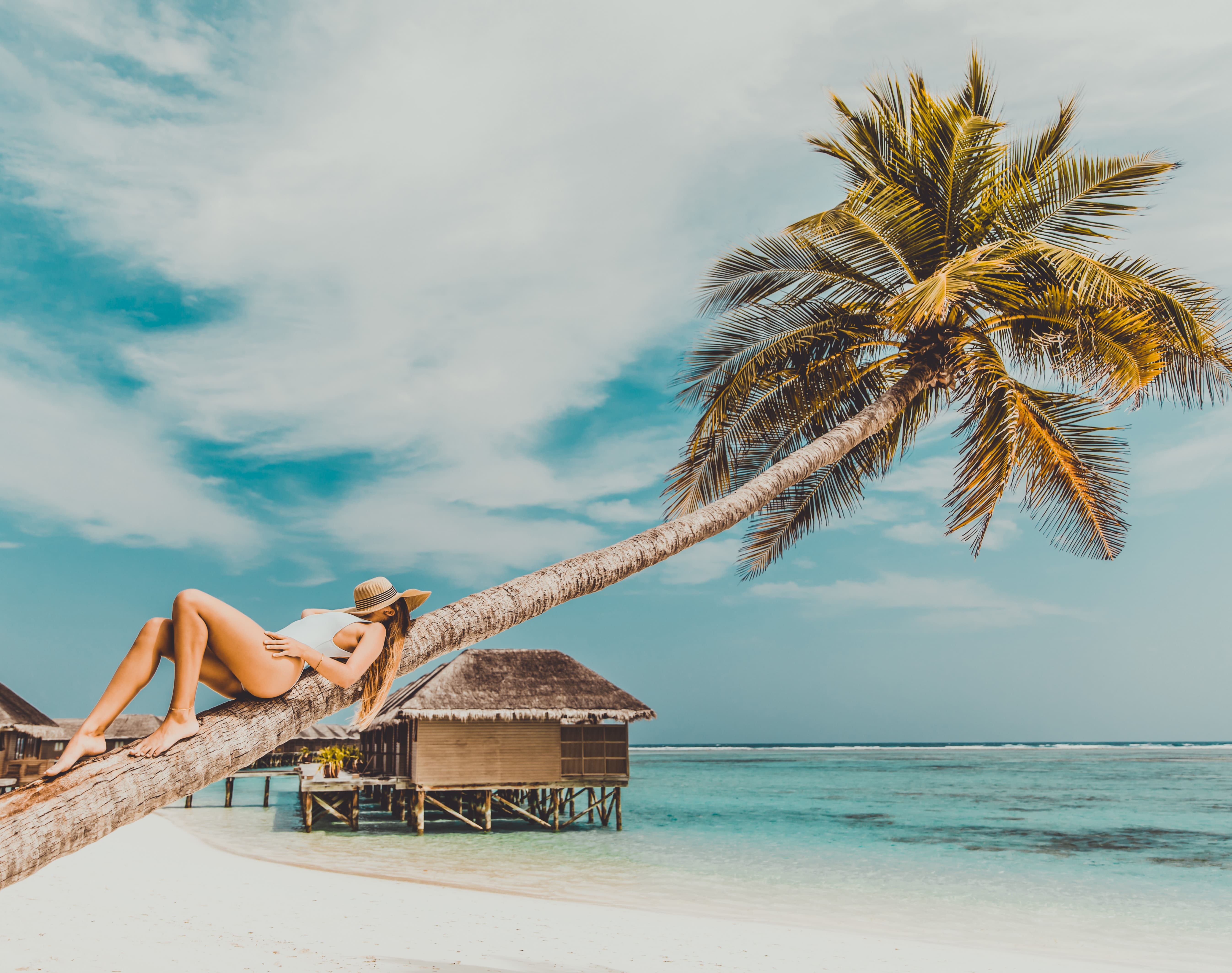 une femme fait la sieste sur un arbre aux maldives